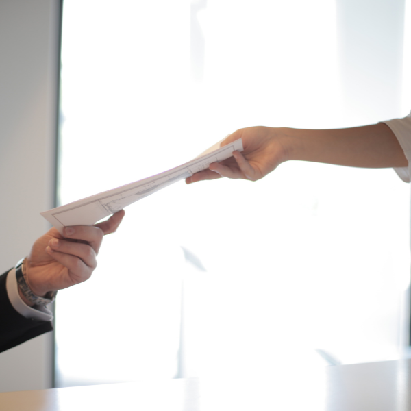 person handing over employment contract to employer