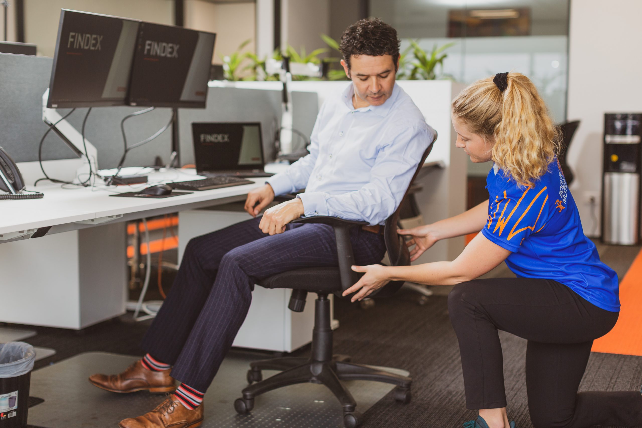 Photo of Body in Motion employee helping an office staff member