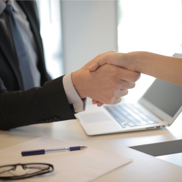 Two people shaking hands over an agreement
