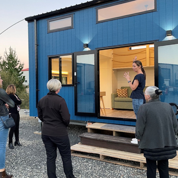 Tiny House Builders owner Rebecca Bartlett stands in front of a tiny house