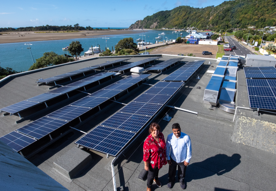 Rachael Burgess and Selva Ganapathy with solar panels at Whakatane office