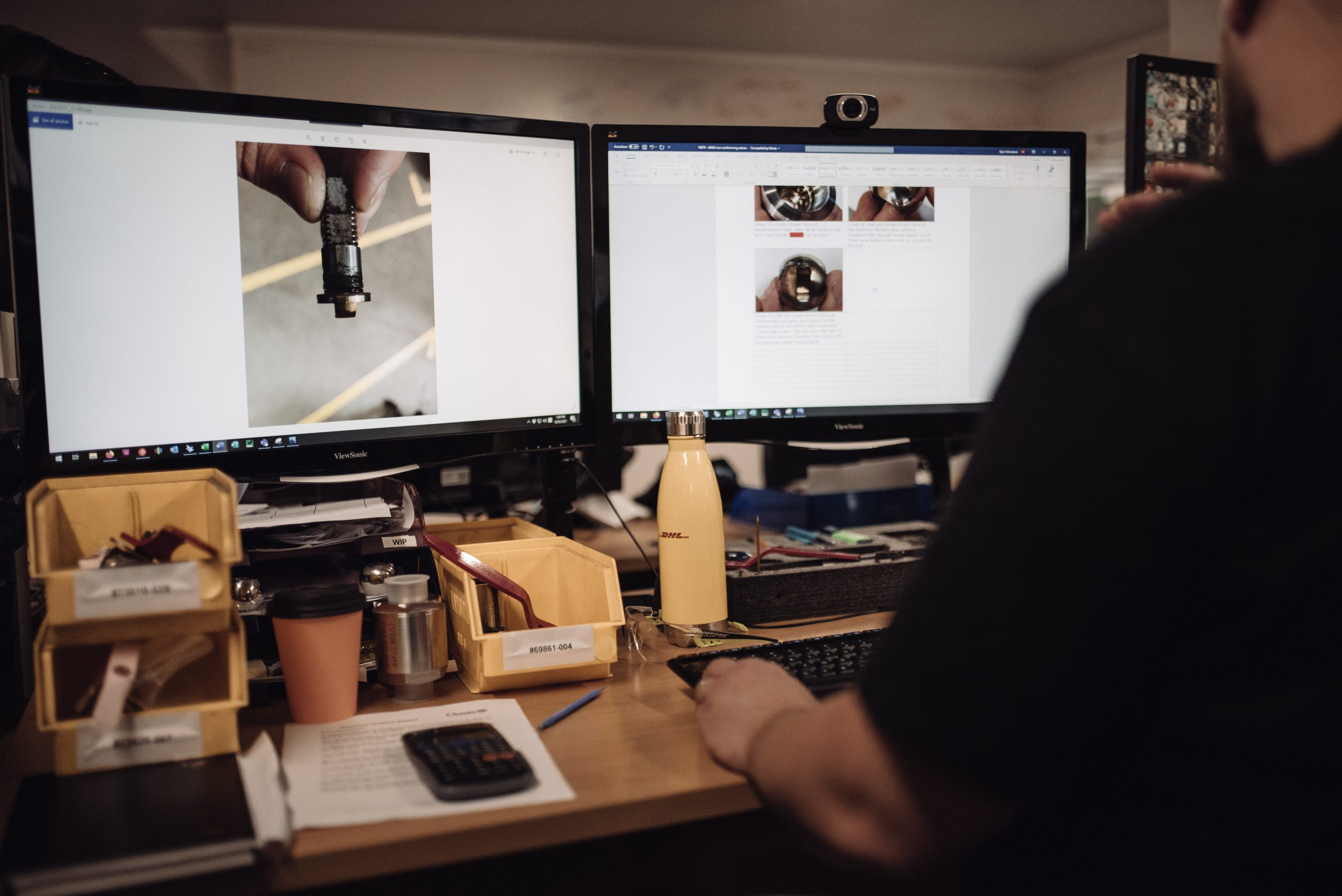 A man works at a computer with two screens