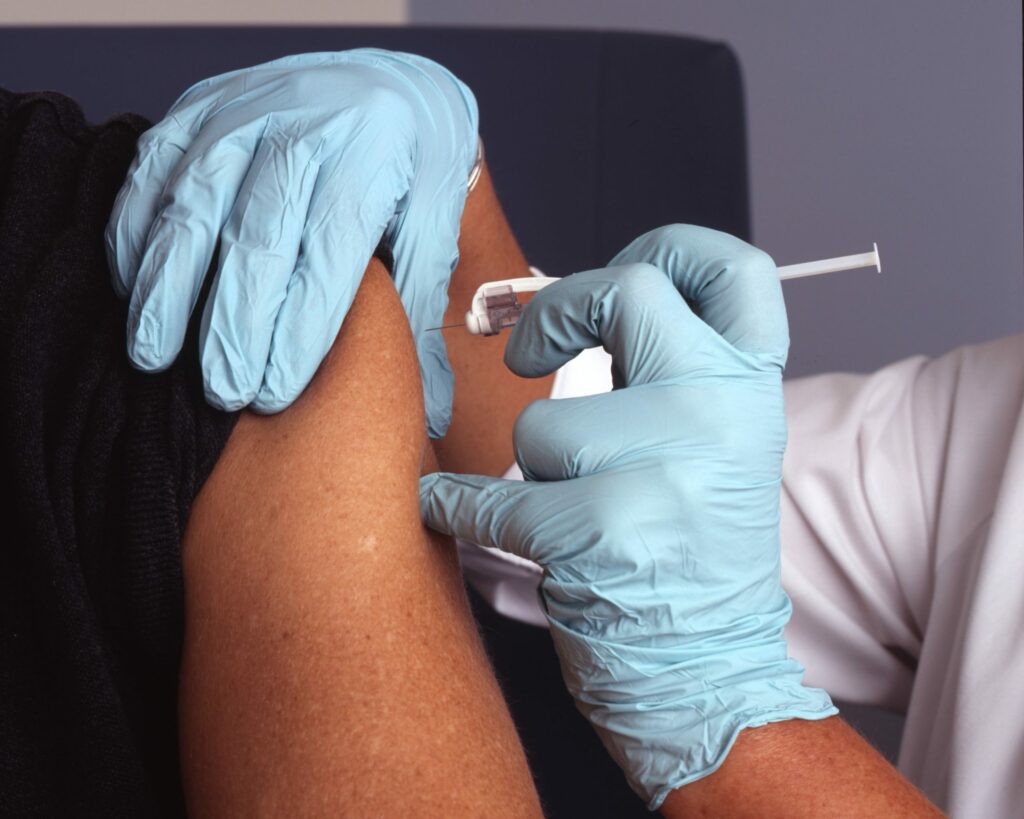 A person getting the COVID-19 vaccine in their arm