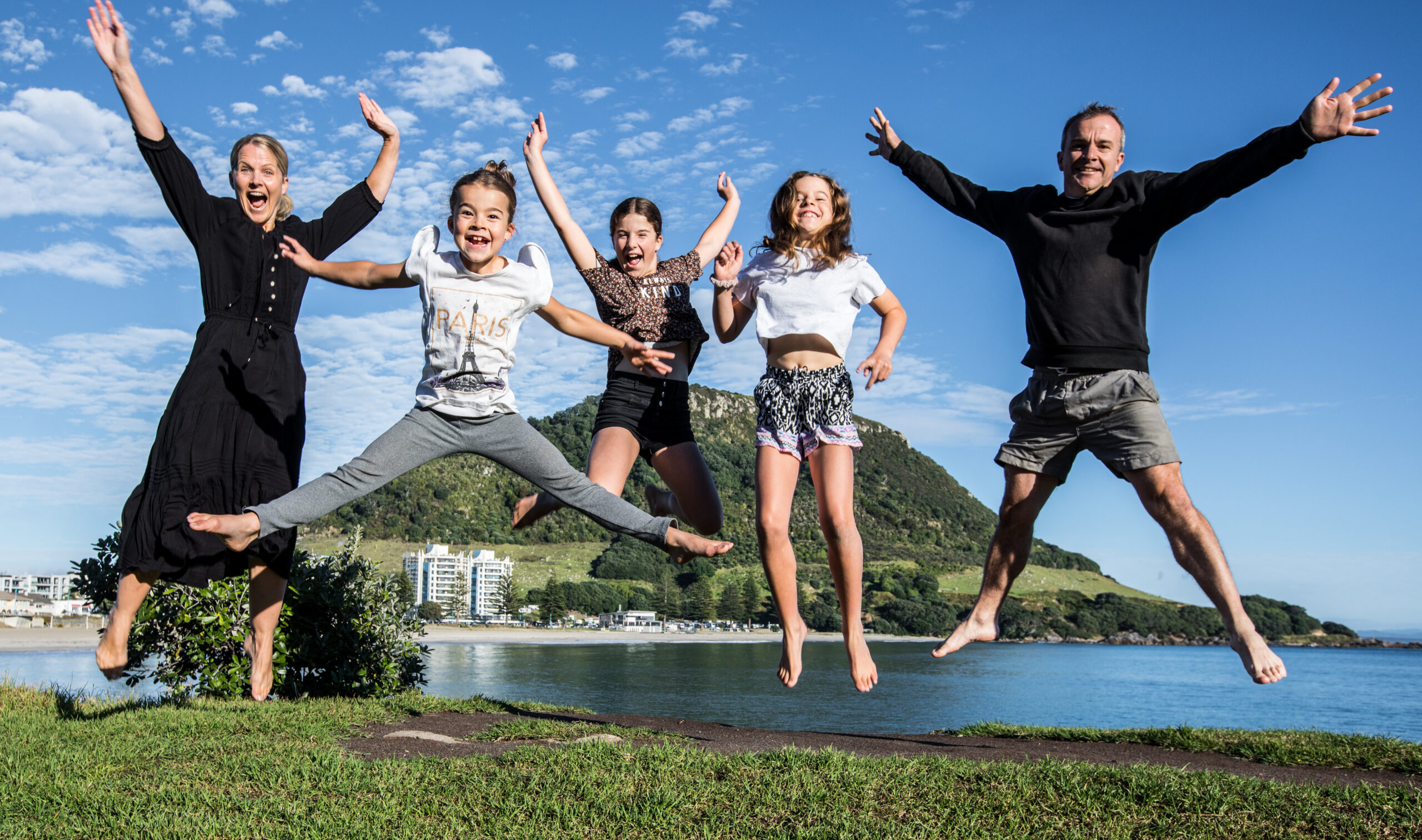 Melissa and Matt Cooke family photo jumping in front of the Mount