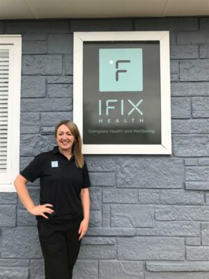 Michelle stands in front of her clinic IFIX Health