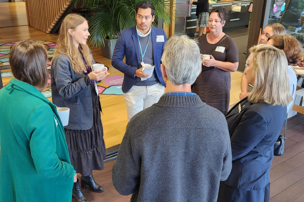 A group of business people networking at an event.