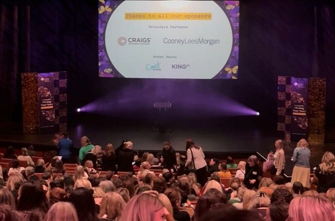 View of audience at Baycourt for Tauranga's BWN Speaker Series 2025, with main sponsors slide